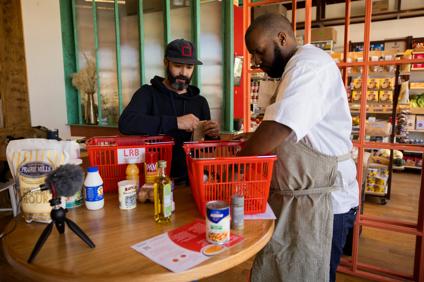 Little Red Box Grocery owner Sam Newman, left, and Cooking Matters chef Dennis Taylor, right, go over ingredients at the Houston East End store.