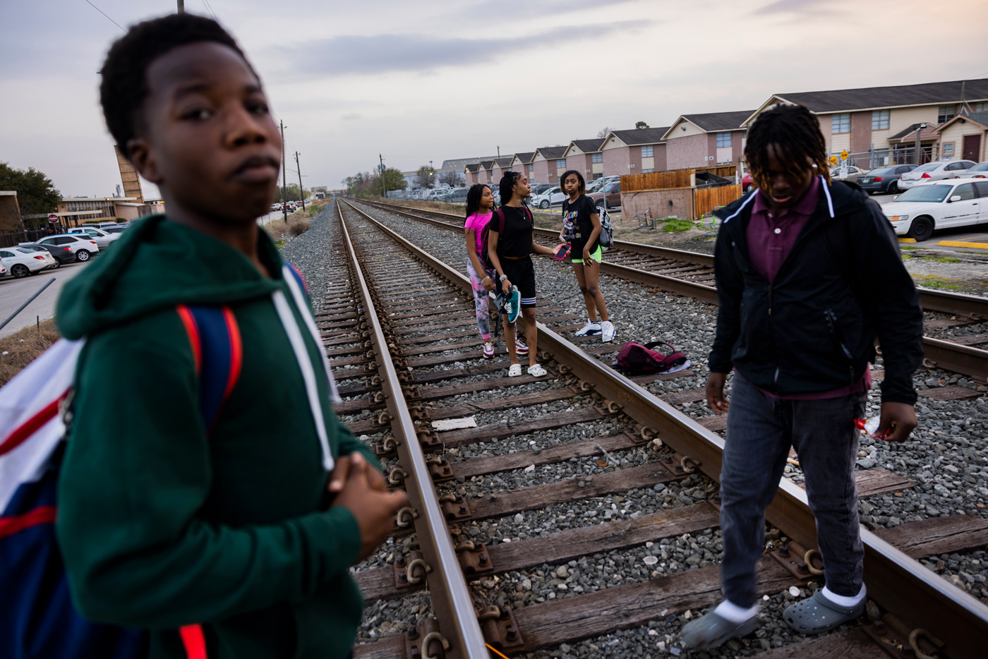 Students walk over railroad tracks