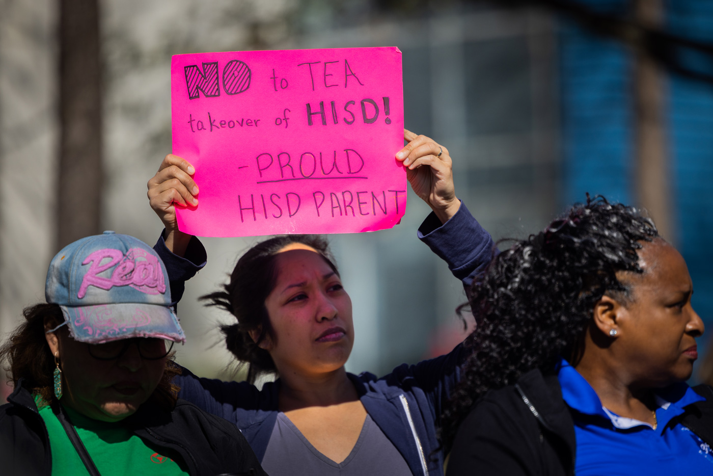 Parent holds a sign during a protest.