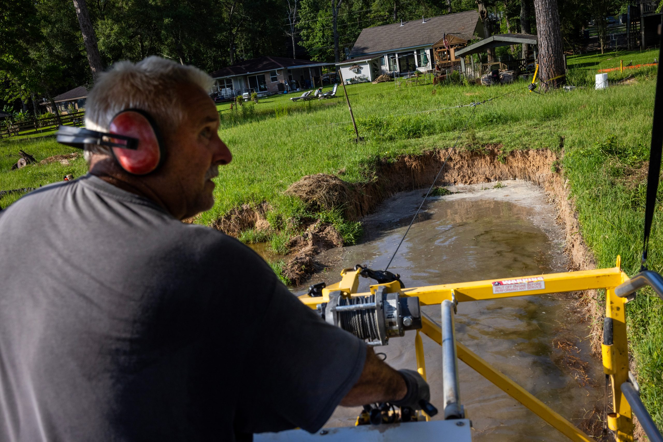 Kevin Hennis spends the morning dredging out silt in a segment of Lake Forest Falls