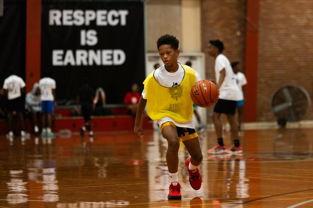 A young basketball player dribbles the ball during a tournament