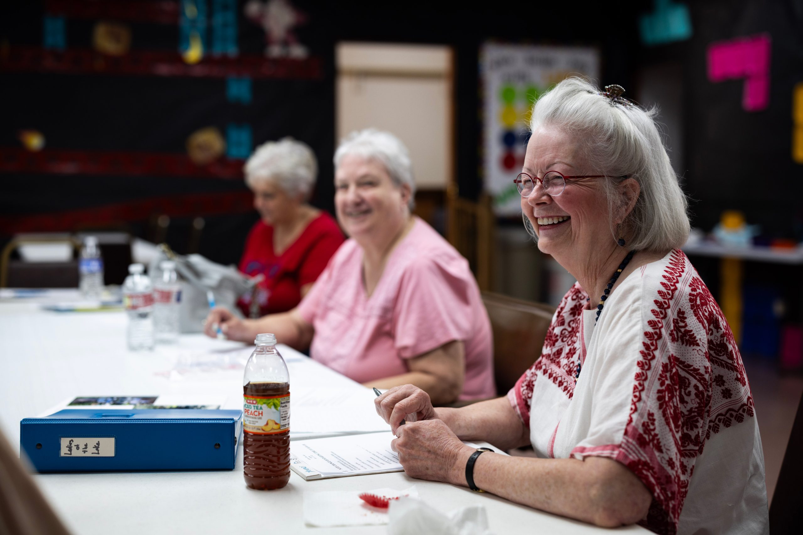 Kay Martin laughs as members of the Ladies of the Lake group plan group trips during a meeting at Mt. Calvary Baptist Church in Lake Forest Falls