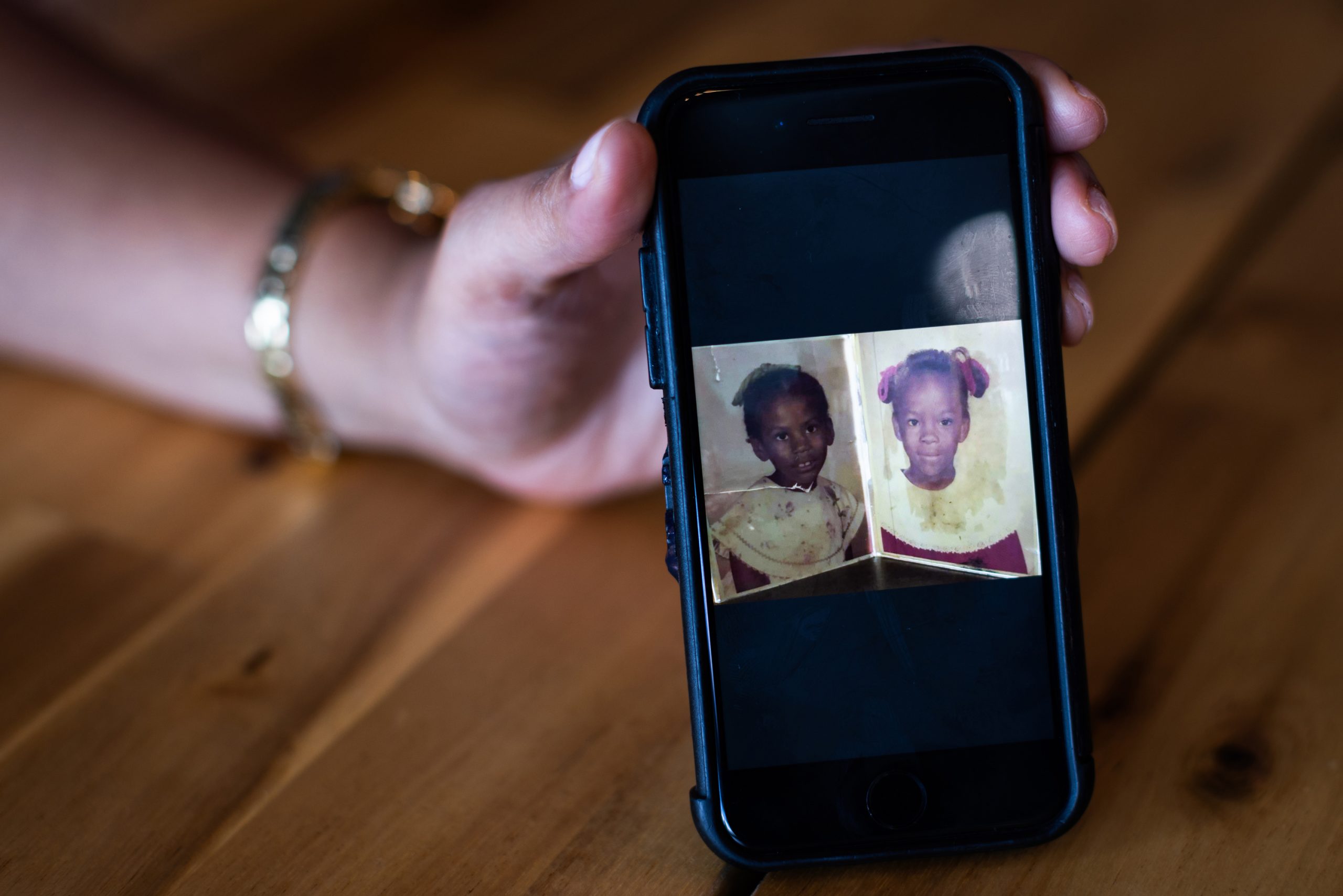 Alesia Morris shows a photo on her cellphone of her and her older sister, Richelle when they were kids.