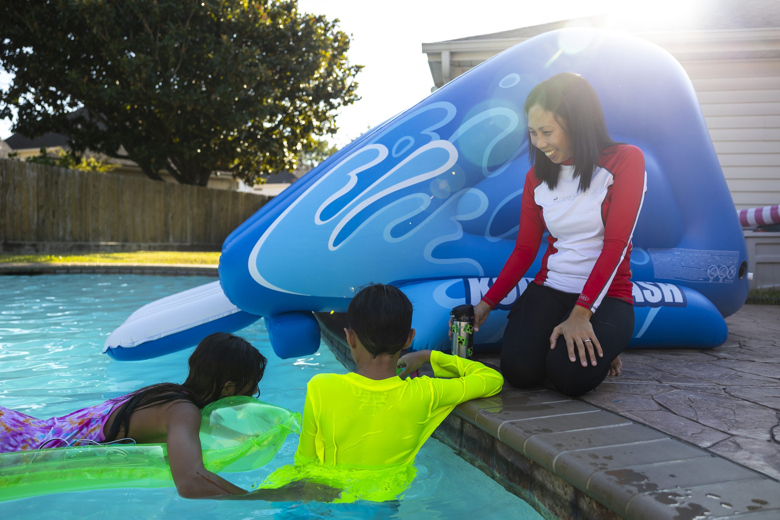 Myhd Montinez, right, watches as her two children swim in their backyard pool Sunday in west Houston. Montinez struggled to get special education services for her son in Houston ISD