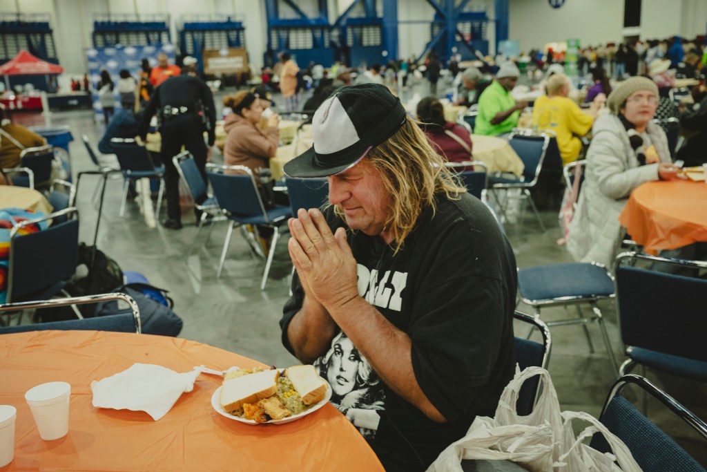 Bruce Smith prayed for God to bless the food and everyone attending the Super Feast, before dining on turkey, sides and pumpkin pie on Thanksgiving Day