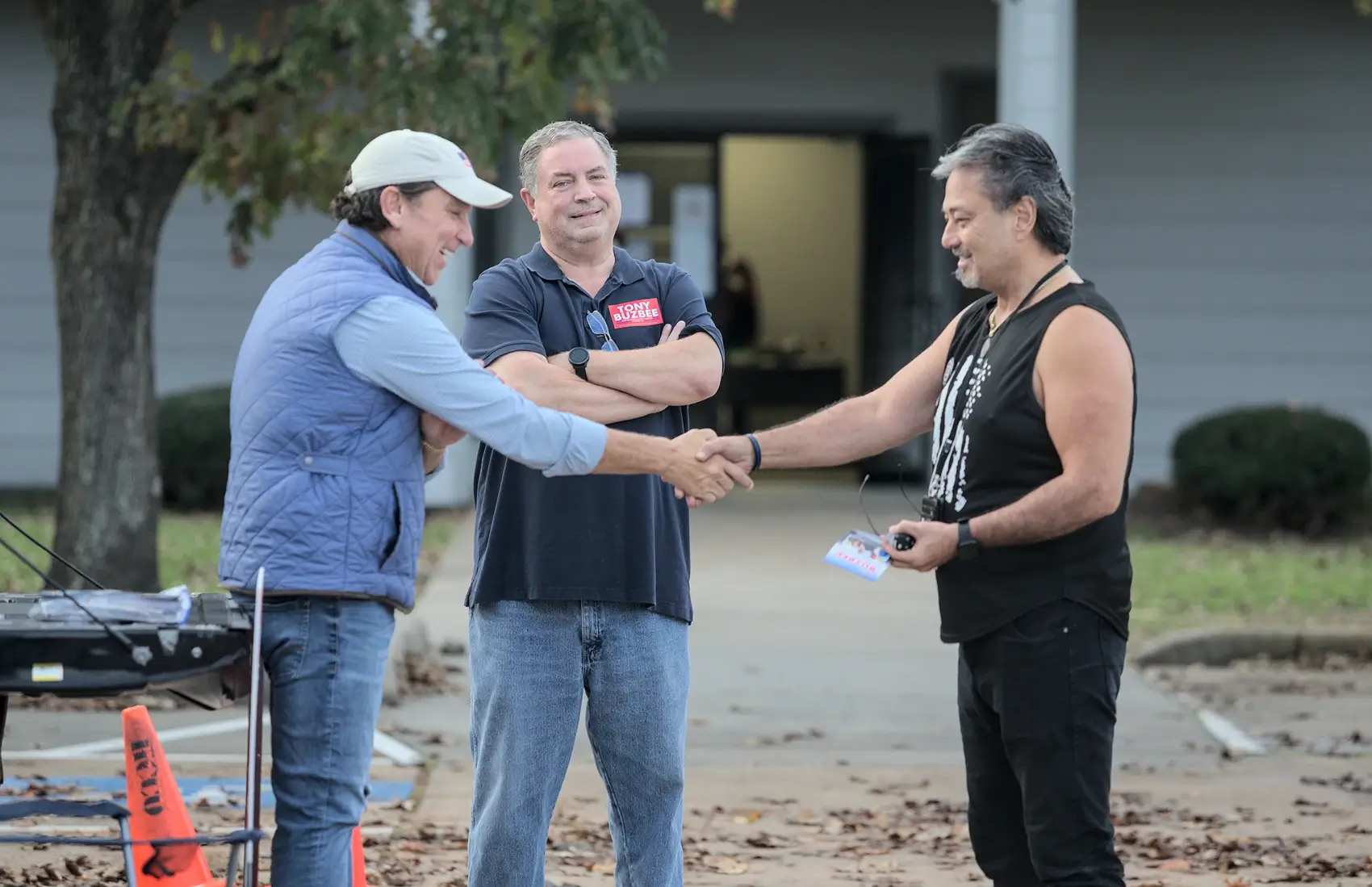 Houston City Council candidate Tony Buzbee, left, shakes hands with Zeb Apostolakis, right, outside a Harris County poll site in Nottingham Park on Election Day. Former City Councilman Greg Travis, center, supports Buzbee's campaign to oust incumbent Mary Nan Huffman.