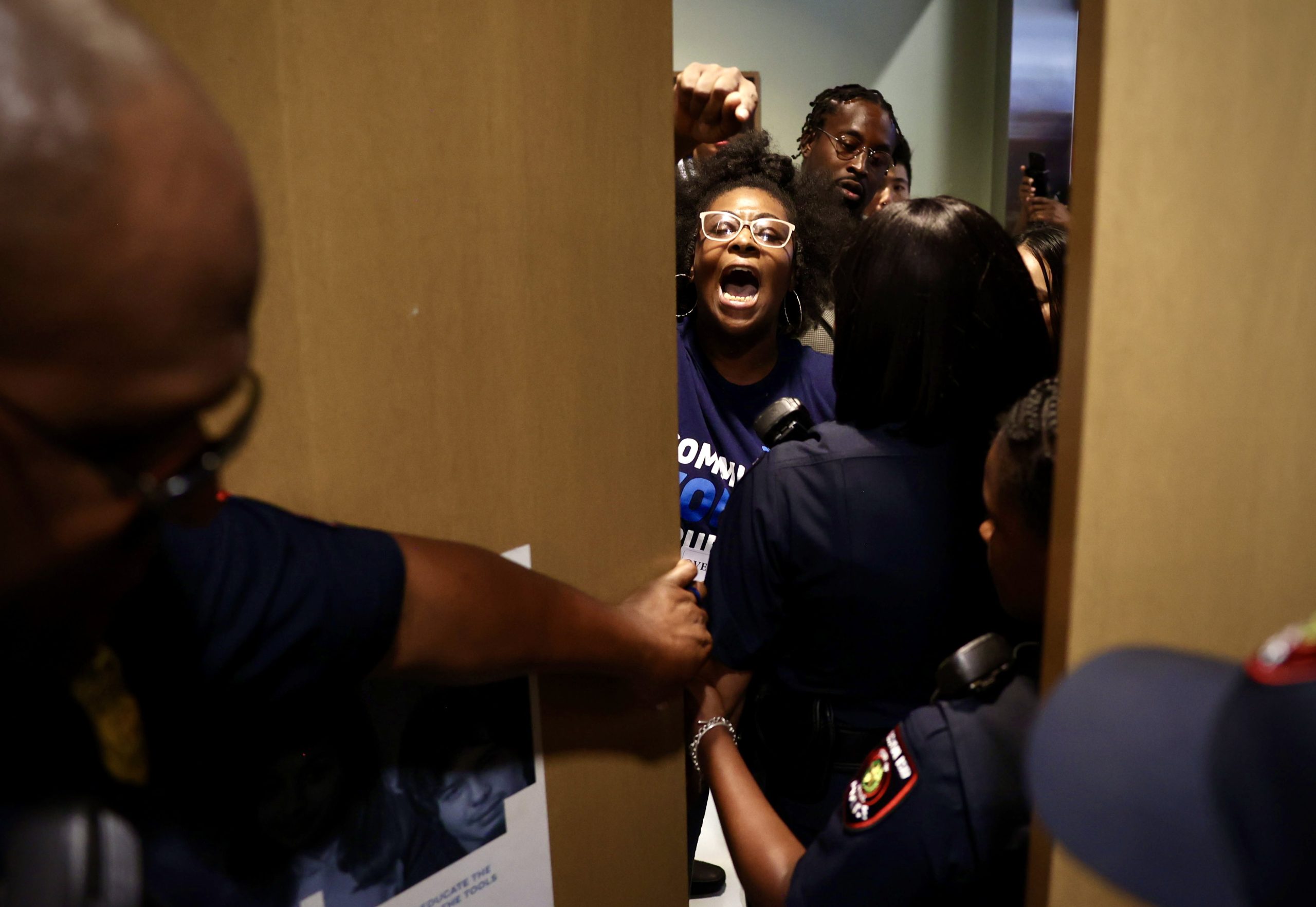 Kourtney Revels protests at an HISD board meeting in Houston.