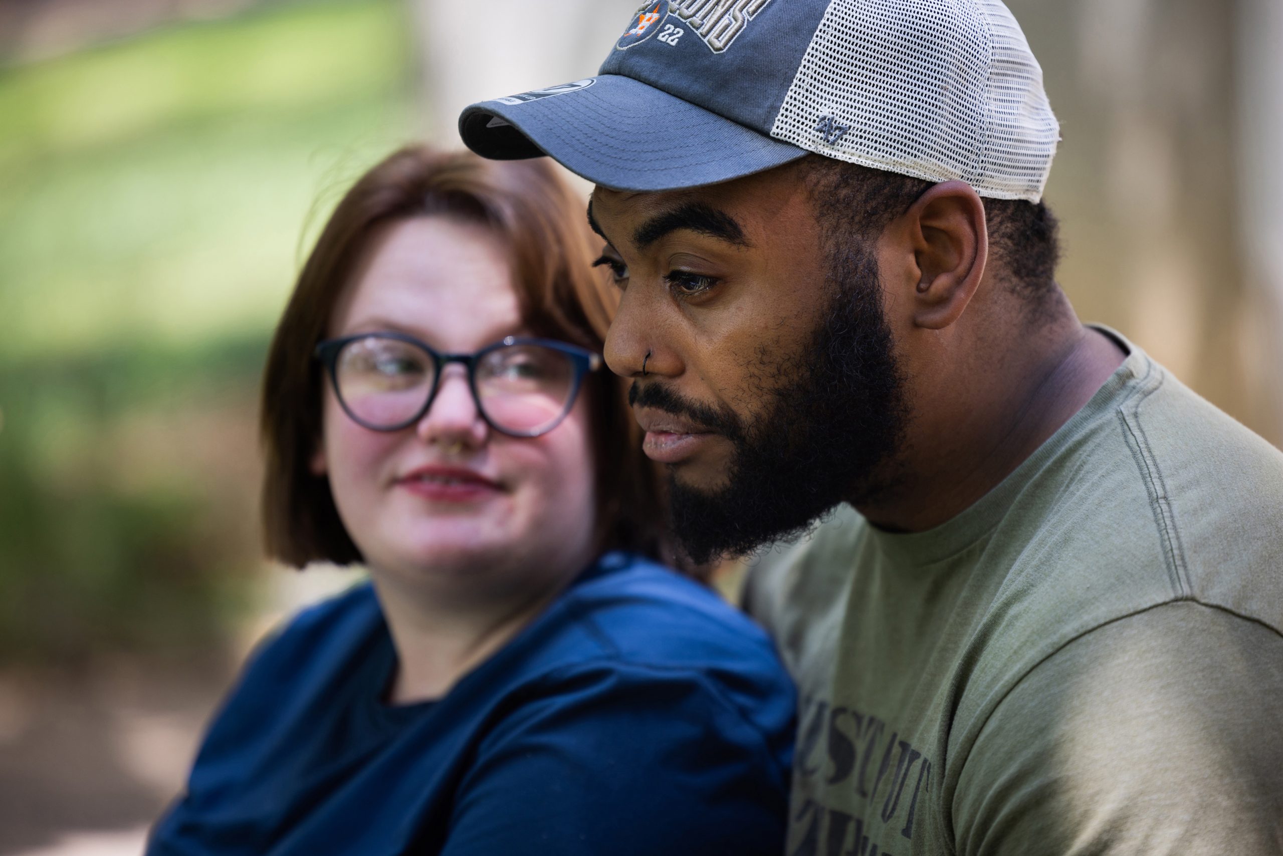 Aaron Morris, right, and his wife, Cyra, pose for a portrait outside their home in Jefferson City, Mo., in August.