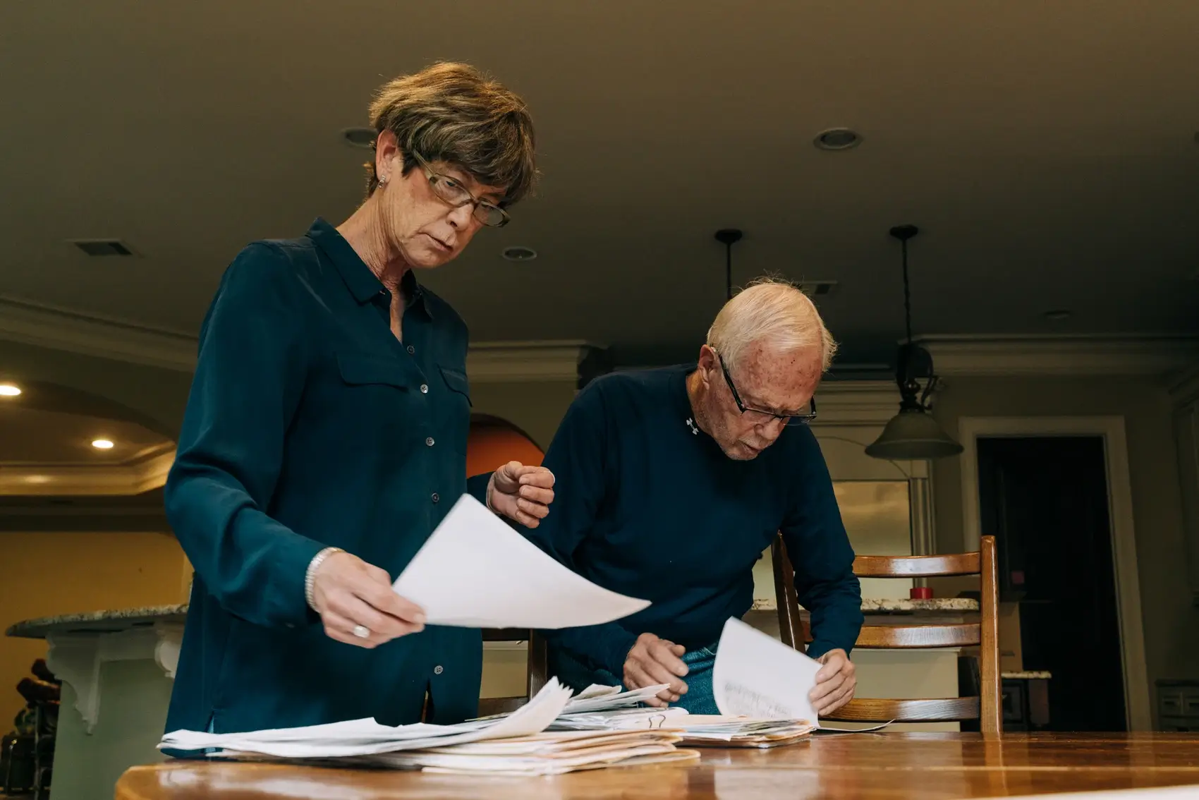 From the left, Susan Davenport and J.C Davenport look through a past water bill showing the shocking charges they're disputing in Houston.